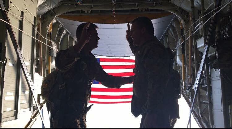 Barracks BBQ co-founder Chase reenlisting alongside his father during a military ceremony inside an aircraft.