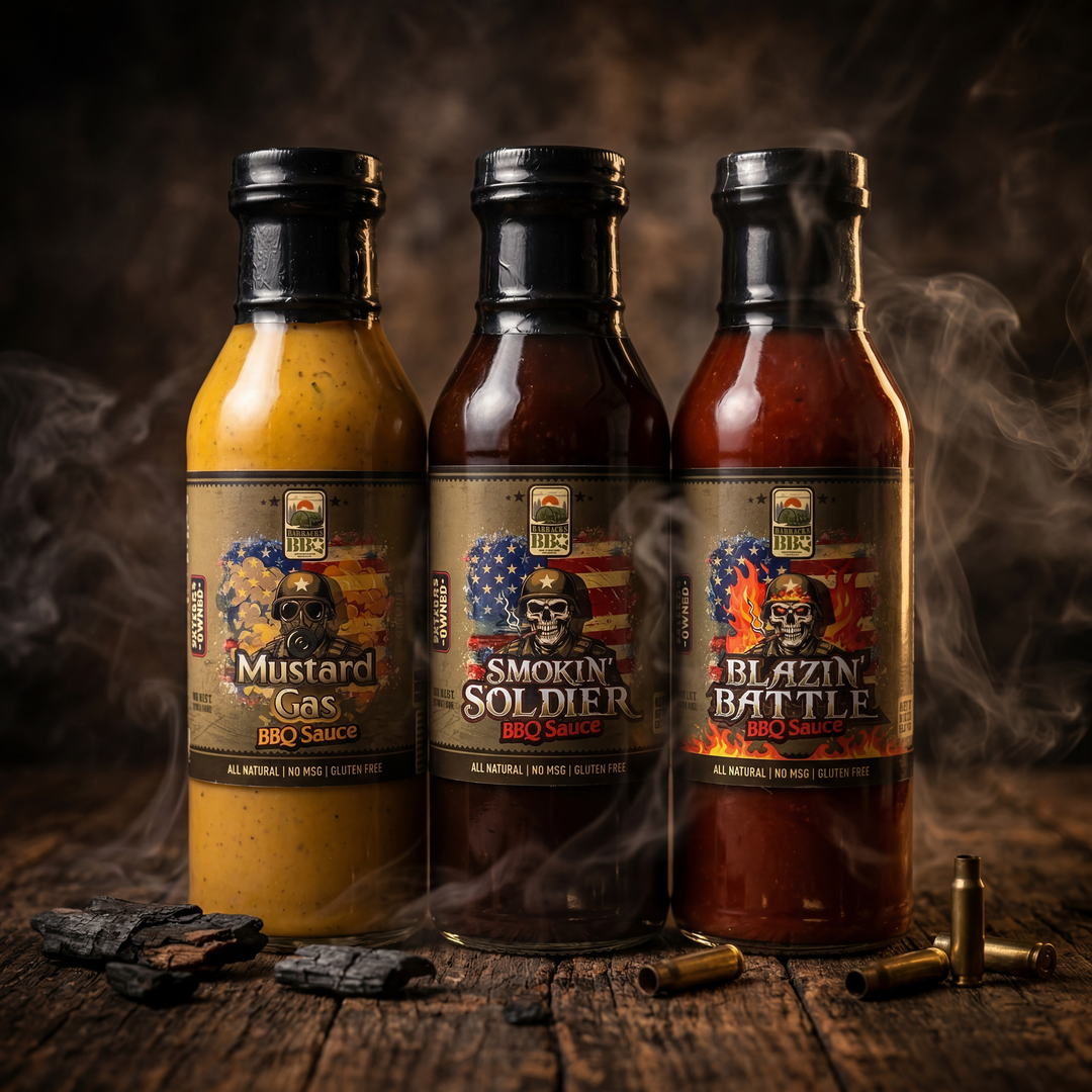 Three Barracks BBQ sauce bottles including Mustard Gas, Smokin’ Soldier, and Blazin’ Battle displayed on a smoky rustic wood surface with dramatic lighting, charred wood, and shell casings